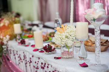 decorations with candles on wedding table in a restaurant