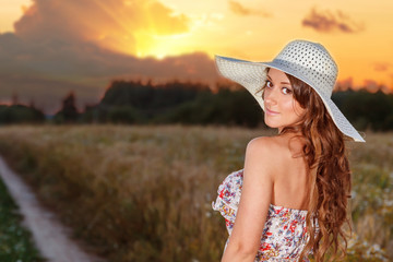 Portrait of young pretty girl dressed in bright hat