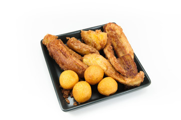 fried bananas on dish black on white background