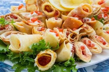 Pancakes stuffed with red caviar.