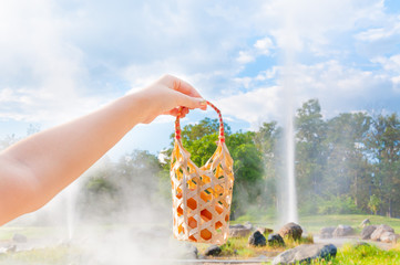 Fototapeta premium women hold basket weave boiled egg in hot spring at San Kamphaeng Hot Springs in Chiang Mai, Northern Thailand