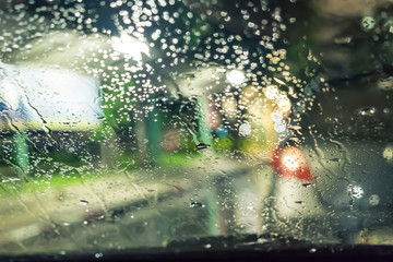Blurred defocused rain windshield light night scene