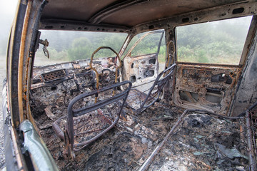 Fototapeta na wymiar The inside of a burnt out car just the shell remains.