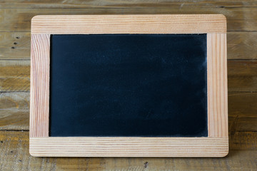 Black chalkboard on a wooden table
