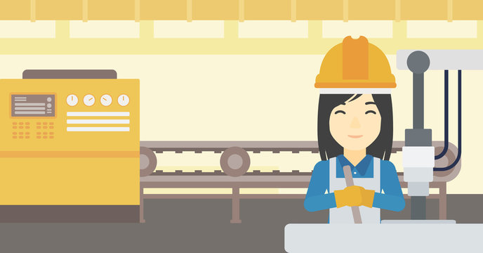Woman working on industrial drilling machine.