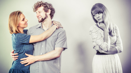 Abandoned woman with enamored couple