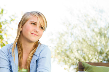 Young teenage girl smiling and reading.