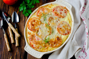 Casserole with rice, sea bass, tomato and cheese