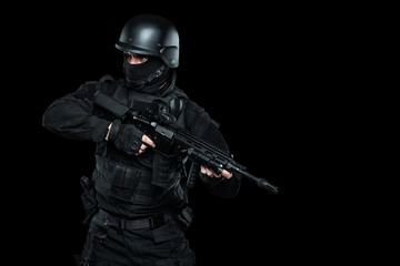 Spec ops police officer SWAT in black uniform and face mask