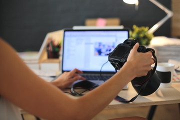 Young photographer and graphic designer at work