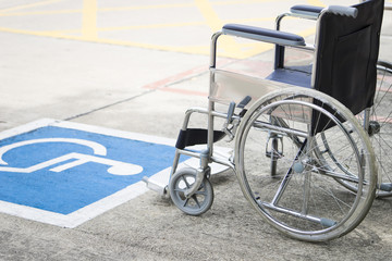Fototapeta na wymiar Pavement handicap symbol and wheelchair