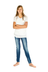 Fototapeta premium Young girl standing with white t-shirt and blue jeans over white