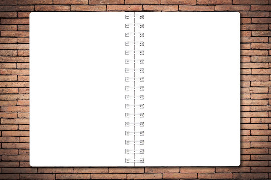 Open notebook paper page on brick wall background for design with copy space for text or image.