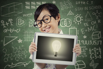 Attractive student shows lightbulb on tablet