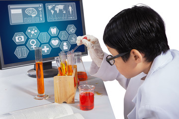 Boy makes experiments with monitor on desk
