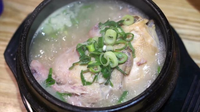 Korean style ginseng chicken soup food. Whole chicken with sticky rice stuffed inside 
