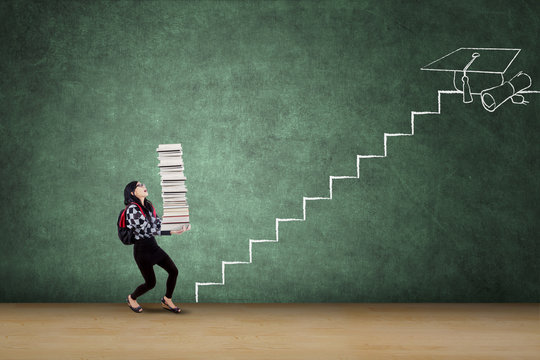 Student with books walks on stairs