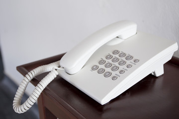 Old telephone on the wooden table.