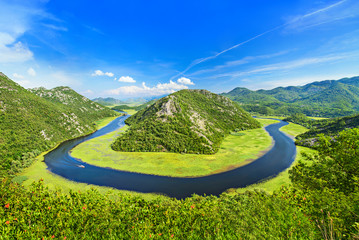Canyon of Rijeka Crnojevica river near the Skadar lake coast. One of the most famous views of Montenegro. River makes a turn between the mountains and flows backward. - obrazy, fototapety, plakaty