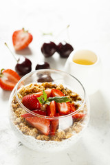 Homemade dessert with granola and berries