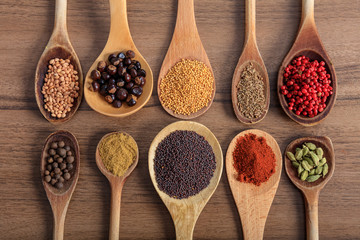 Variety of spices on a wooden surface