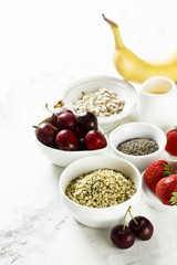 Healthy food. Fruits, seeds and berries on white table