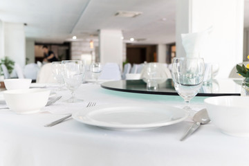 wooden table in dining room with elegant table setting