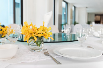 wooden table in dining room with elegant table setting