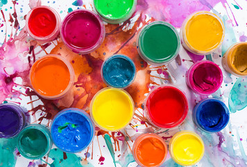 Paints, brushes and watercolor painted background. The workplace of the artist. Banner for school