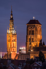 Fototapeta na wymiar Towers of the town hall and St Mary's church in Gdansk, Poland