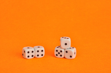 A collection of dice that is displayed on an orange background
