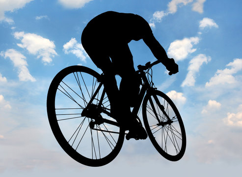 silhouette of cyclist against the blue sky 