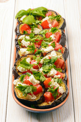 Appetizers - grilled eggplants with garlic, feta cheese and tomatoes.