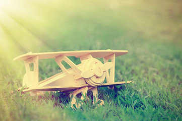 Closeup wooden plane toy on grass