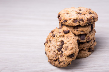 close up of chocolate cookies stacked on wooden table