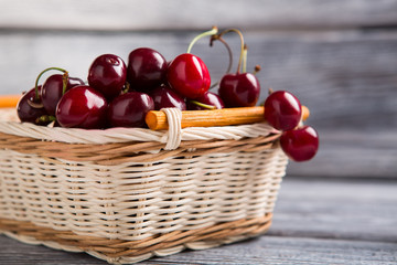 Basket filled with cherries. Dark red fruit. Improve kidney health. Fresh and sweet.