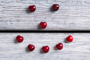 Smiley made of cherries. Red fruit on wooden surface. Make your immunity stronger. Summer welcomes you.