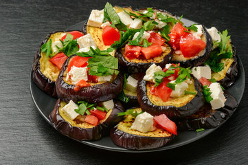 Appetizers - grilled eggplants with garlic, feta cheese and tomatoes.