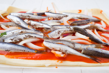detail, preparation of sardines on puff pastry ready to bake