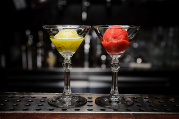 two glasses with green and red sorbet - obrazy, fototapety, plakaty
