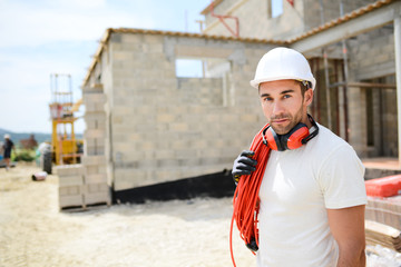 portrait of handsome construction worker on a building industry construction site