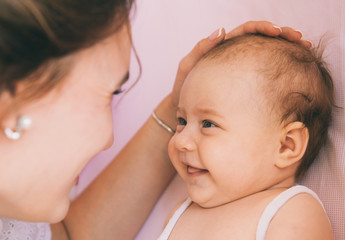 Close-up portrait cute smiling baby 3 month with mom. Family at home. © Romanova Anna