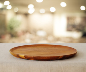 Empty wooden round tray over blurred cafe background - Powered by Adobe