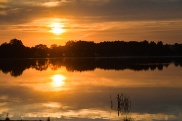 Fototapeta premium View to river with reflections and blue cloudy sky,