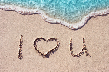 I love u handwritten on the beach with blue ocean wave on background