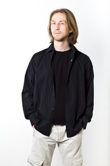 Portrait of young man with long blond hair, black shirt, white b