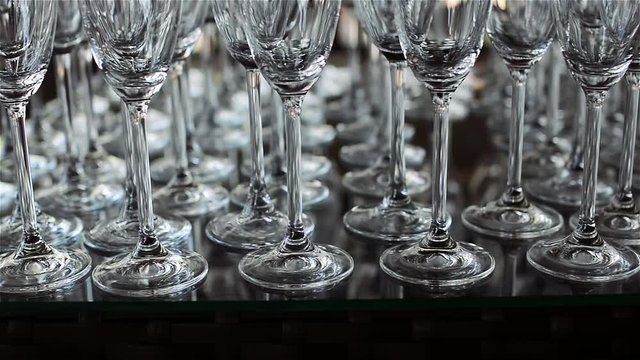 Rows of Empty Wine or of Champagne Glasses on the table for a Stylish Wedding