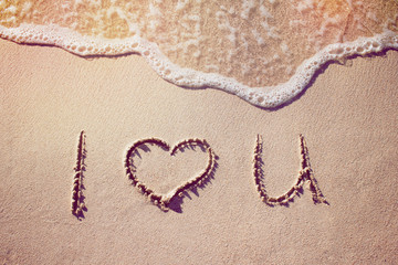 the word love on a tropical beach