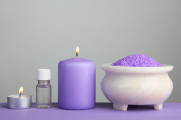 Obraz na płótnie Canvas Essential oil with aromatic salt on a purple background. The concept of aromatherapy.