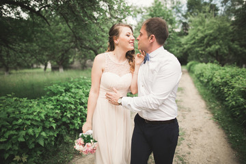 Luxury married wedding couple, bride and groom posing in park